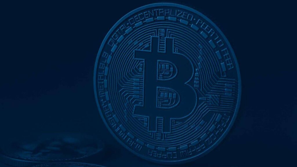 A large golden Bitcoin coin on a dark financial background symbolizing the launch of BlackRock's Bitcoin ETP in Europe